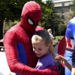Spiderman hugging a child