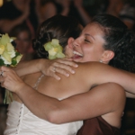 Bride hugging friend at wedding